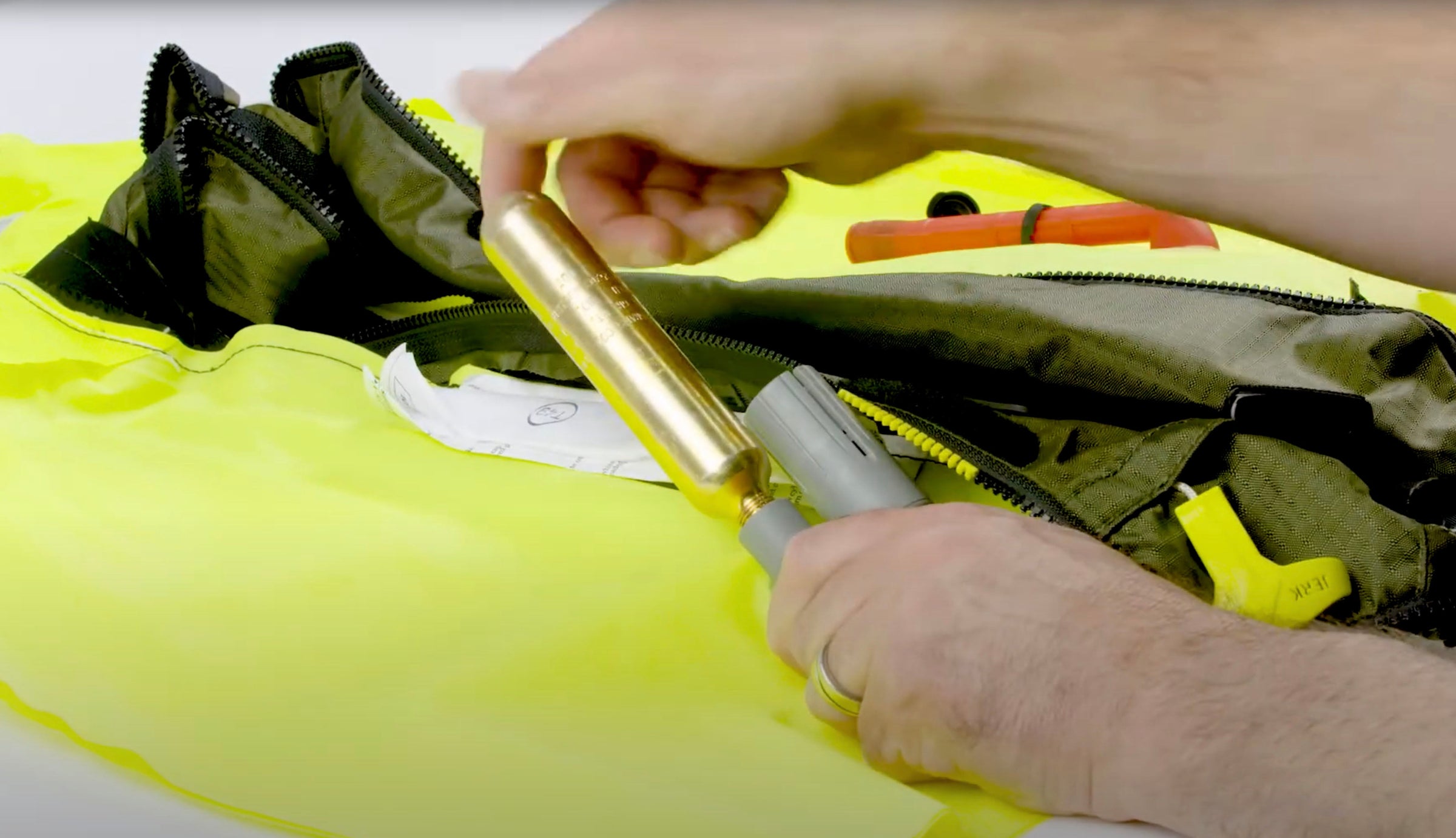 Closeup image of a Rearming kit being installed into an inflatable Onyx Personal Flotation Device.