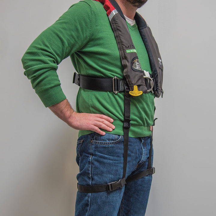Person in a green sweater wearing Universal Thigh Straps, ITEM #139900-700-004-17.