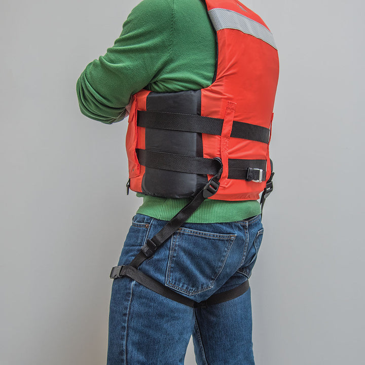 Confident person in Universal Thigh Straps over green sweater, red life jacket, and blue jeans.
